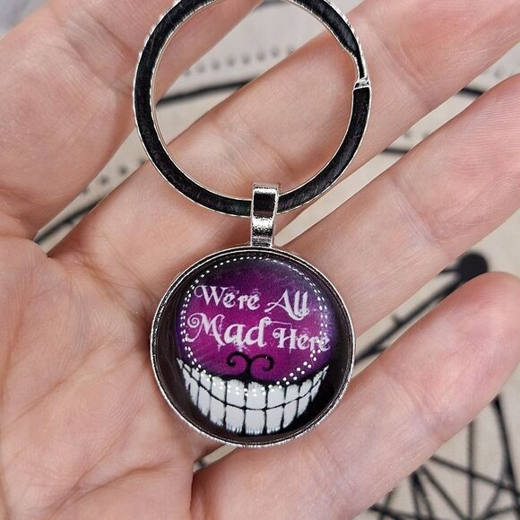 Cheshire cat smile, we are all made here glow in the dark keychain - Picture 5 of 7